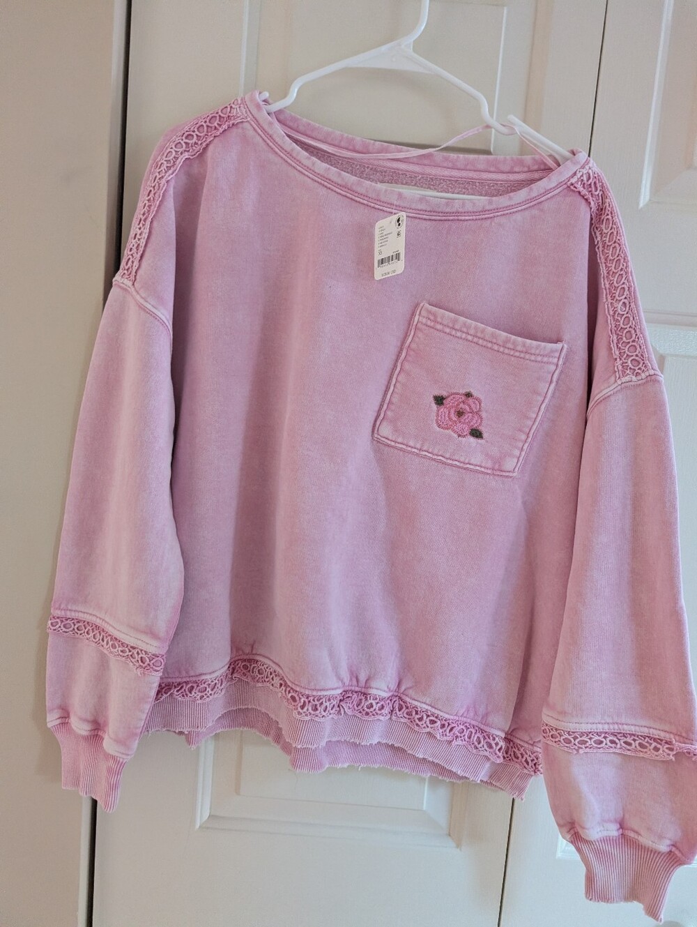 Pink sweatshirt with lace trim on sleeves and hem